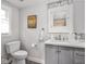 Simple half bathroom with grey vanity, white countertops and classic fixtures at 150 E 46Th St, Indianapolis, IN 46205
