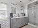 Bathroom with wallpaper, double vanity with vessel sinks, and walk-in shower at 150 E 46Th St, Indianapolis, IN 46205