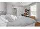 Bedroom with hardwood floors, a ceiling fan and a door leading to another room at 150 E 46Th St, Indianapolis, IN 46205
