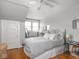 Bedroom features hardwood floors, two windows, and a ceiling fan at 150 E 46Th St, Indianapolis, IN 46205