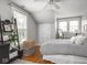 Bright bedroom features hardwood floors, two windows, and a ceiling fan at 150 E 46Th St, Indianapolis, IN 46205