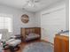 Cozy Bedroom with wooden crib, soft lighting, and hardwood floors, creating a comforting space for relaxation at 150 E 46Th St, Indianapolis, IN 46205