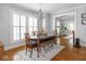 Dining room featuring shuttered windows, chandelier and wooden table and chairs at 150 E 46Th St, Indianapolis, IN 46205