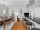 Open concept dining room with wood floors, chandelier, breakfast bar, and views to the living room at 150 E 46Th St, Indianapolis, IN 46205