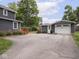 Exterior view of the home and detached garage, and a long driveway at 150 E 46Th St, Indianapolis, IN 46205