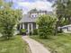 Charming home with a welcoming front yard, walkway, and landscaped features at 150 E 46Th St, Indianapolis, IN 46205