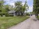 Charming home featuring a well-manicured lawn, mature trees, and a long driveway at 150 E 46Th St, Indianapolis, IN 46205