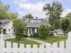 Beautiful house showcasing a lush green lawn, mature trees, and a quaint walkway to the front door at 150 E 46Th St, Indianapolis, IN 46205