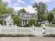Charming home featuring a white picket fence, well-manicured lawn, and inviting curb appeal at 150 E 46Th St, Indianapolis, IN 46205