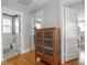 Hallway with hardwood floors and a wooden cabinet at 150 E 46Th St, Indianapolis, IN 46205