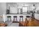 Kitchen breakfast bar with pendant lights, stainless steel appliances and white cabinets at 150 E 46Th St, Indianapolis, IN 46205
