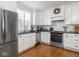 Bright kitchen with stainless steel appliances, white cabinets, and wood floors at 150 E 46Th St, Indianapolis, IN 46205