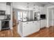 Kitchen island with dark countertops, white cabinets, and view of the dining area at 150 E 46Th St, Indianapolis, IN 46205