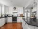 Modern white kitchen with stainless steel appliances and wood floors at 150 E 46Th St, Indianapolis, IN 46205