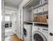 Efficient laundry room with modern washer and dryer, shelving, and ample space, making laundry tasks a breeze at 150 E 46Th St, Indianapolis, IN 46205