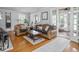 Comfortable living room with leather sofa, armchair, wood floors and area rug at 150 E 46Th St, Indianapolis, IN 46205