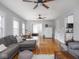 Living room with hardwood floors, ceiling fans, and a comfortable sectional at 150 E 46Th St, Indianapolis, IN 46205