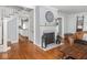 Open-concept living room with wood floors, fireplace, and staircase at 150 E 46Th St, Indianapolis, IN 46205