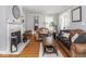 Cozy living room showcases a fireplace, hardwood floors, and comfortable leather seating at 150 E 46Th St, Indianapolis, IN 46205
