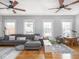 Living room with hardwood floors, ceiling fans, and sectional sofa at 150 E 46Th St, Indianapolis, IN 46205