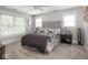 Inviting main bedroom with plush carpeting, tufted headboard, and three bright windows at 150 E 46Th St, Indianapolis, IN 46205