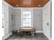 Mudroom with wooden bench, storage, hooks and bright window for natural light at 150 E 46Th St, Indianapolis, IN 46205