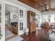 Bright sunroom featuring tiled floors, a wood ceiling, a vintage cabinet, and dining set at 150 E 46Th St, Indianapolis, IN 46205