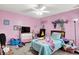 Pink bedroom features a ceiling fan, TV and desk area at 15264 Ten Point Dr, Noblesville, IN 46060