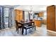 Open-concept dining area with pendant lighting, stainless steel appliances, and sliding door to the deck at 15264 Ten Point Dr, Noblesville, IN 46060