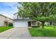 Inviting two-story home featuring a two-car garage, lush green lawn, and a mature shade tree at 15264 Ten Point Dr, Noblesville, IN 46060