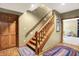 Basement staircase with hardwood flooring and natural wood banister leading to the lower level at 15264 Ten Point Dr, Noblesville, IN 46060
