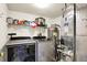 A functional utility room featuring modern washer and dryer, and water heater with storage shelves at 15264 Ten Point Dr, Noblesville, IN 46060