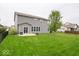 Large private fenced backyard with lush green lawn and patio at 15675 Myland Dr, Noblesville, IN 46062