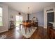 Inviting dining room features hardwood floors, contemporary lighting, and easy access to the backyard at 15675 Myland Dr, Noblesville, IN 46062