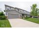 Two-story home with a two-car garage, green lawn, and walkway to covered front porch at 15675 Myland Dr, Noblesville, IN 46062