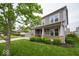Gray two-story house featuring a brick front porch and a perfectly manicured green lawn at 15675 Myland Dr, Noblesville, IN 46062