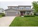 Charming two-story home with a well-maintained lawn and a two car attached garage at 15675 Myland Dr, Noblesville, IN 46062