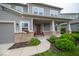 Inviting covered front porch with brick accents, columns and manicured hedges at 15675 Myland Dr, Noblesville, IN 46062