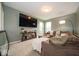 Comfortable living room with plush seating, plenty of natural light, and an entertainment center at 15675 Myland Dr, Noblesville, IN 46062