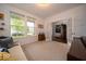 Carpeted living room with large window, french doors, and a glimpse of the foyer at 15675 Myland Dr, Noblesville, IN 46062