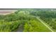 Aerial view of a beautiful property with a pond, grassy areas, and dense tree coverage at 1820 N 1100 E, Sheridan, IN 46069