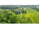 A panoramic view of a sprawling estate with a pool, playground, lush lawns, and dense woodlands creating a private retreat at 1820 N 1100 E, Sheridan, IN 46069