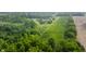 An aerial shot capturing a sprawling estate with in-ground pool, playground, and vast green fields, surrounded by dense forest at 1820 N 1100 E, Sheridan, IN 46069