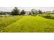 Spacious backyard featuring a well-manicured lawn, playground, house, barn and white fence at 1820 N 1100 E, Sheridan, IN 46069