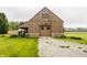 Quaint wooden barn with gravel drive and a stone foundation, surrounded by trees at 1820 N 1100 E, Sheridan, IN 46069