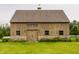 Charming wooden barn with a stone foundation, set amongst a lush green landscape and beautiful landscaping at 1820 N 1100 E, Sheridan, IN 46069