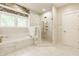 Bright bathroom with a soaking tub, glass shower and stylish tile at 1820 N 1100 E, Sheridan, IN 46069