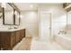 Bright bathroom with a double sink vanity, marble floors, a soaking tub and modern fixtures at 1820 N 1100 E, Sheridan, IN 46069