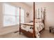 Bedroom with four poster bed, natural light from window, and neutral color palette at 1820 N 1100 E, Sheridan, IN 46069