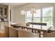 Bright dining room with a wooden table, modern chandelier, and large windows overlooking the backyard at 1820 N 1100 E, Sheridan, IN 46069
